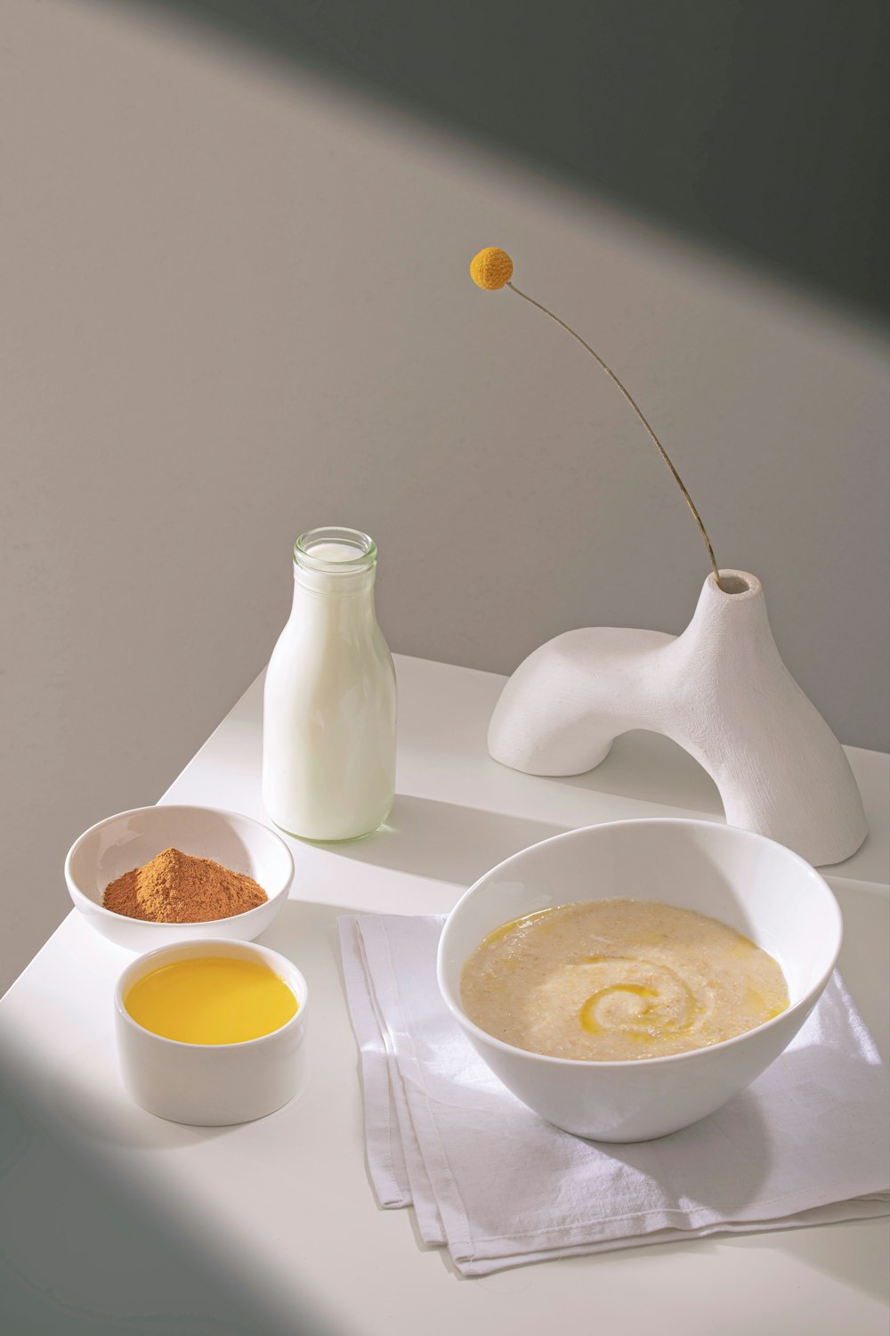 a white table topped with bowls of food