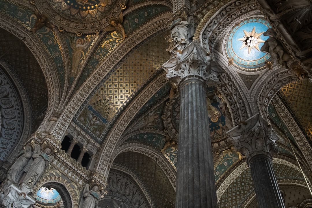 the ceiling of a large building with a clock on it