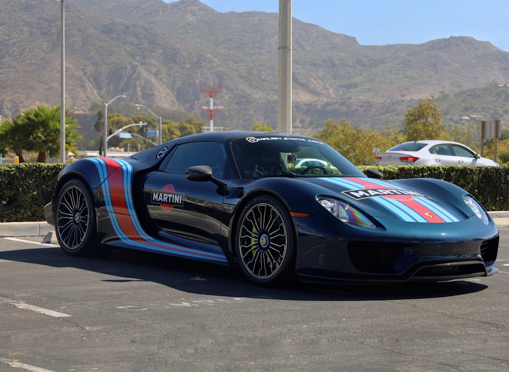 a blue sports car parked in a parking lot