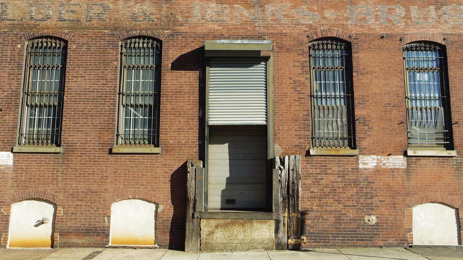 An older brick building with a closed industrial door
