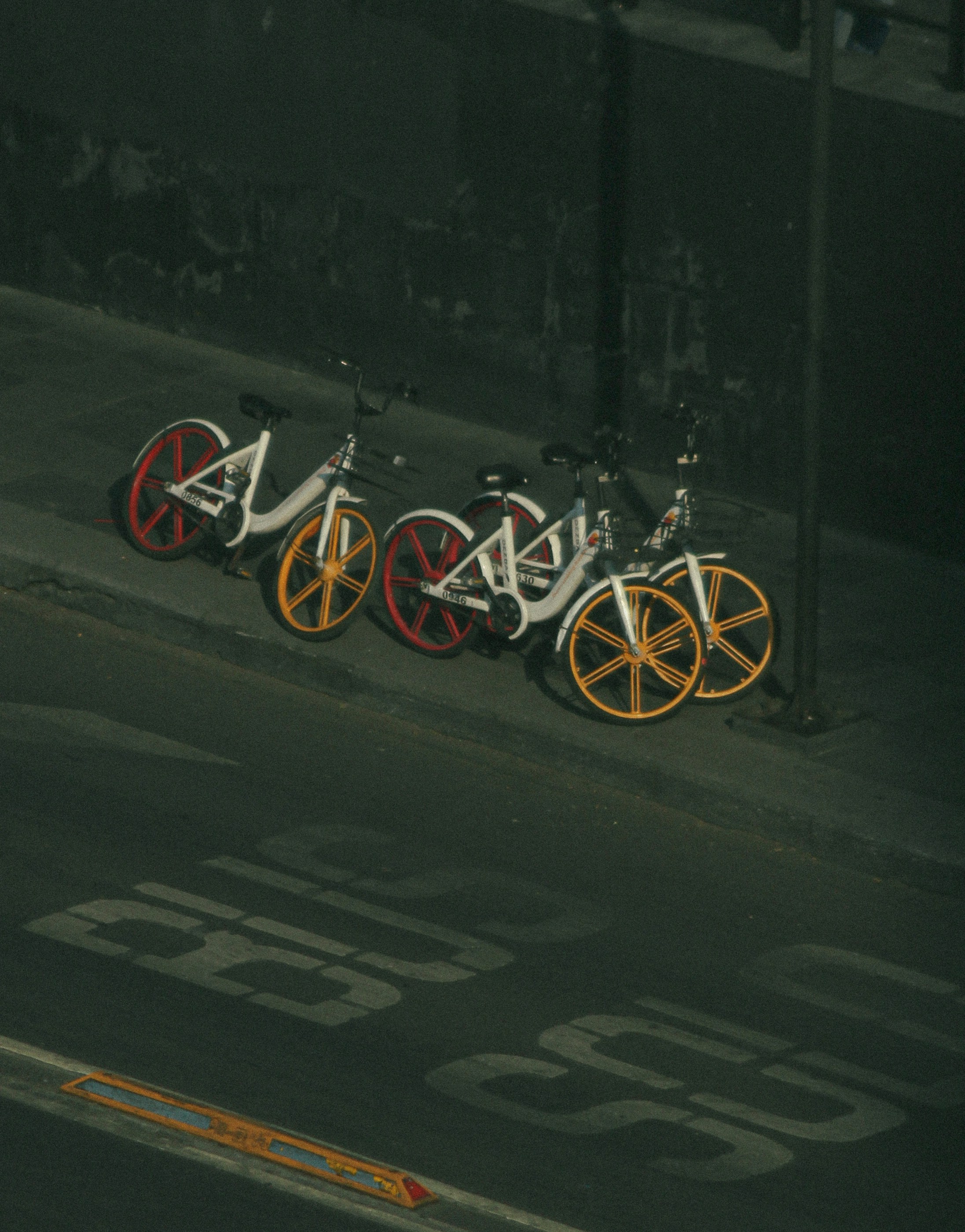 a row of bikes parked next to each other on a street