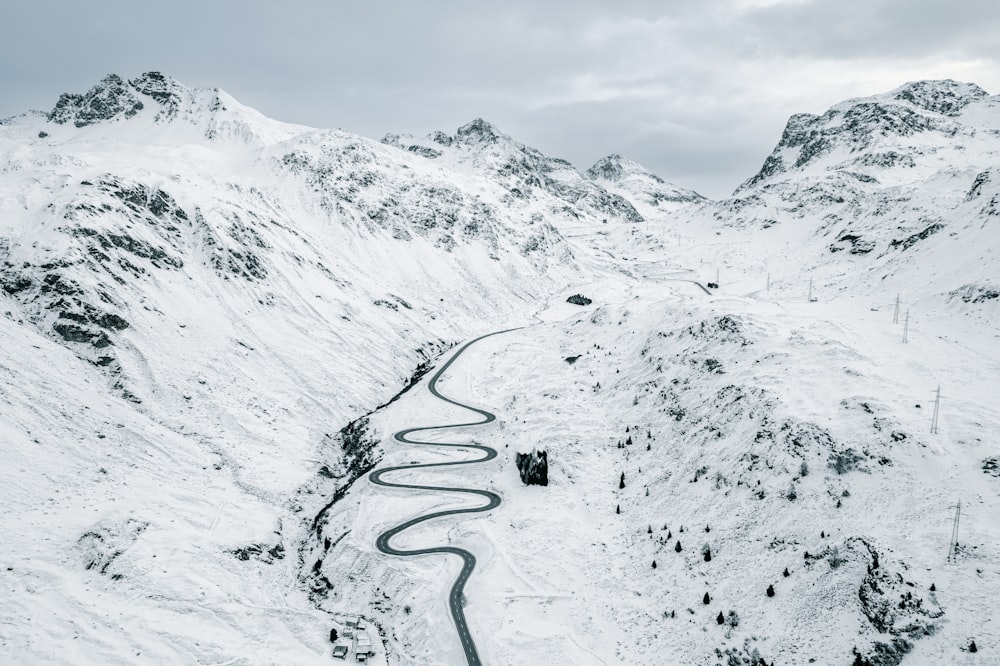 a winding road in the middle of a snowy mountain