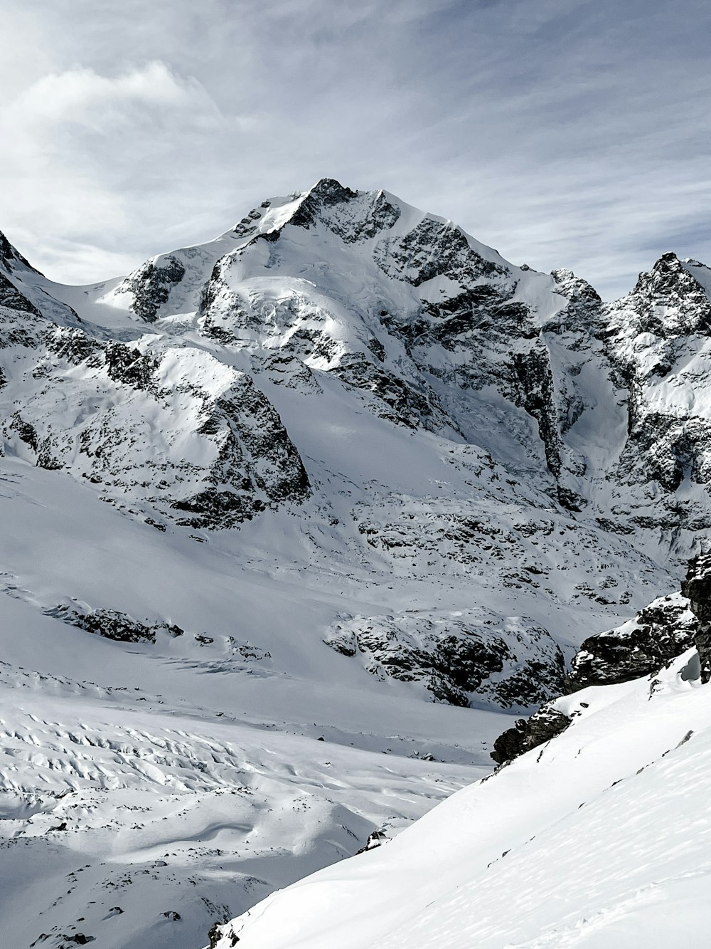 a man riding skis down the side of a snow covered slope