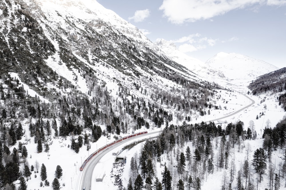 a train traveling through a snow covered mountain