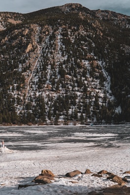 Engineers reviewing environmental impact maps beside a frozen lake in the Northwest Territories.