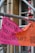 A brightly colored banner in German is attached to scaffolding. The banner has a pink and orange background with bold black text. It promotes a campaign against violence with a reference to '16 Tage gegen Gewalt an Frauen' and includes dates.