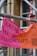 A brightly colored banner in German is attached to scaffolding. The banner has a pink and orange background with bold black text. It promotes a campaign against violence with a reference to '16 Tage gegen Gewalt an Frauen' and includes dates.