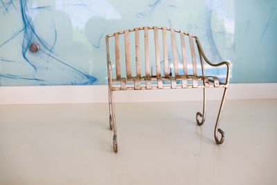 A sleek metal entryway bench with a rustic finish placed in a cozy hallway.