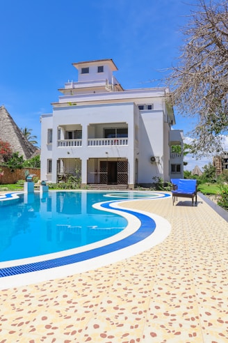 a house with a swimming pool in front of it