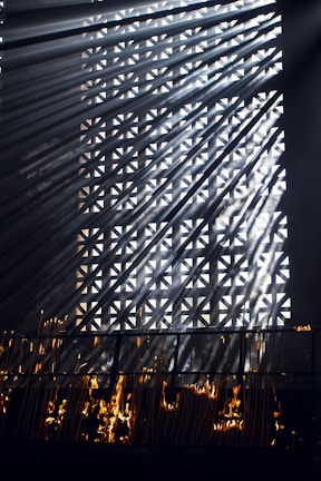 Soft sunlight filtering through ancient temple incense smoke curling upwards.