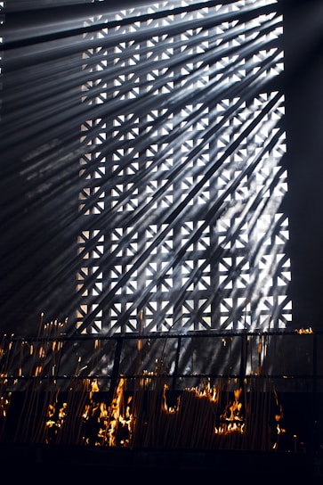 Soft morning light filtering through a serene meditation space with incense smoke gently rising.