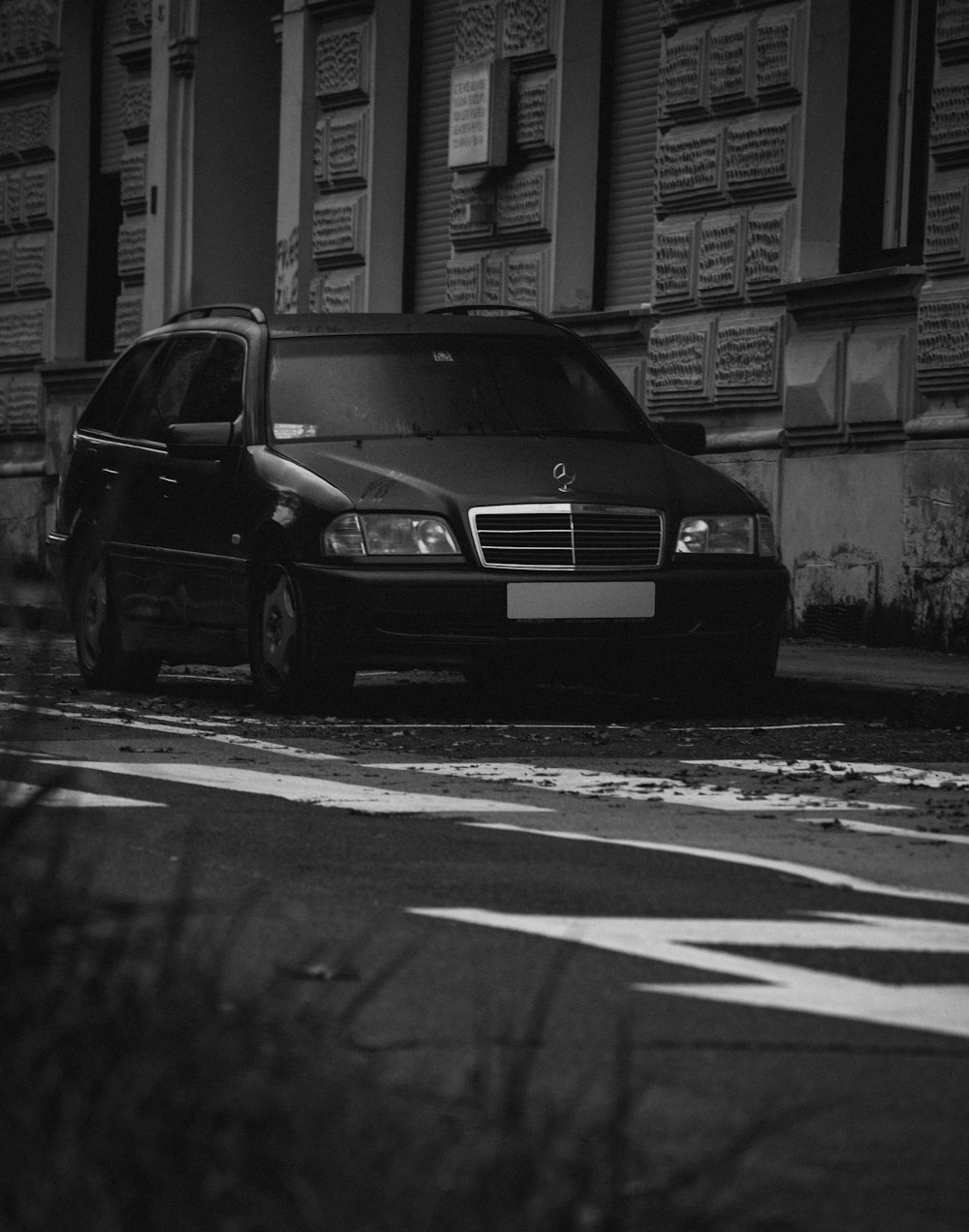 a black car parked on the side of the road