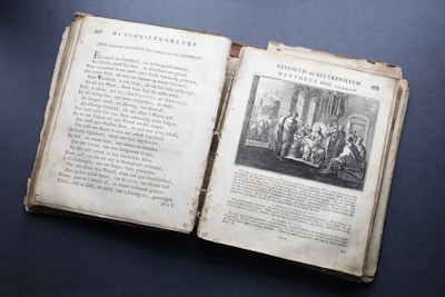 A vintage open book with symbolic illustrations on aged paper.