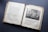 An open antique book featuring pages with text in an old font style on the left and an illustration on the right. The illustration depicts a biblical scene with several figures in a historical setting. The paper appears aged, with yellowed edges and some wear.