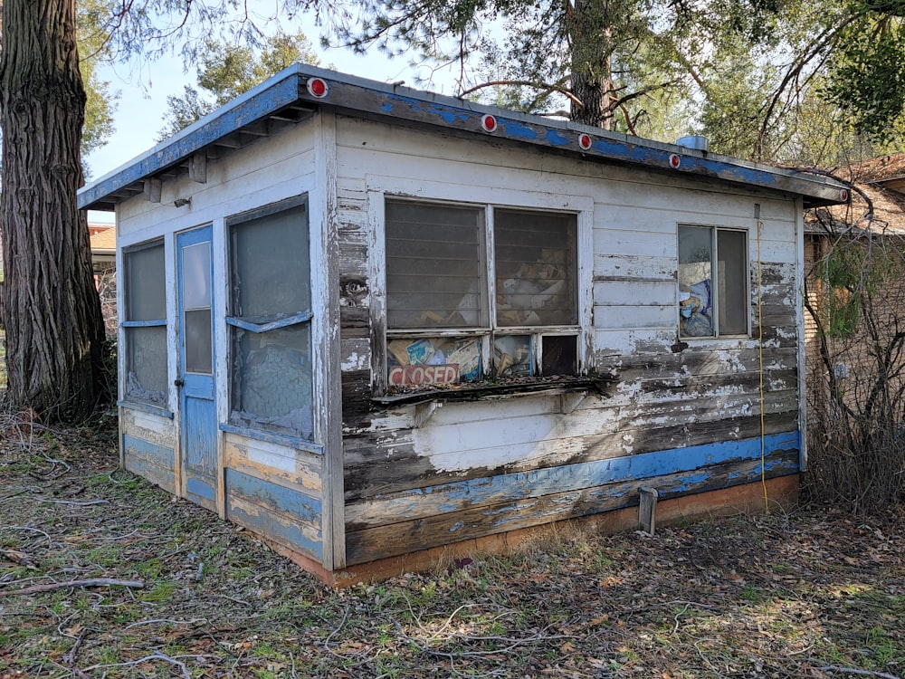 an old run down outhouse in the woods