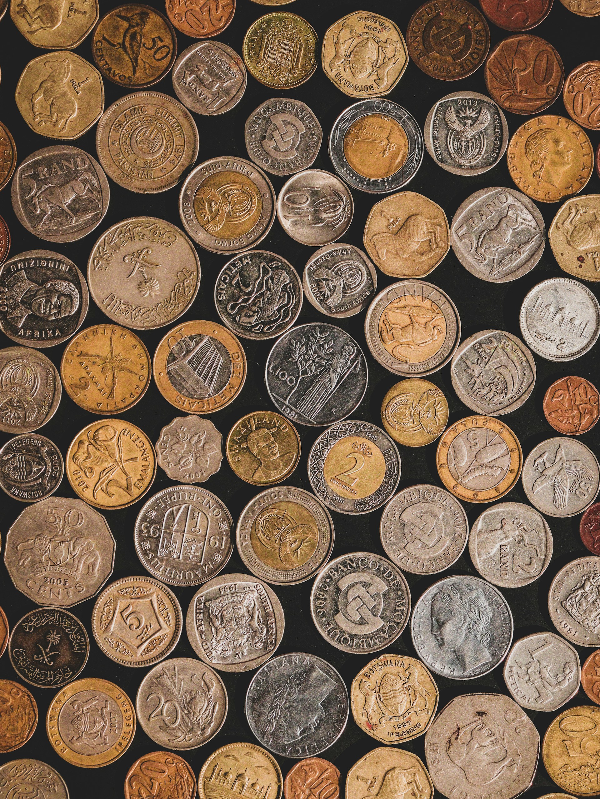 a pile of different types of coins