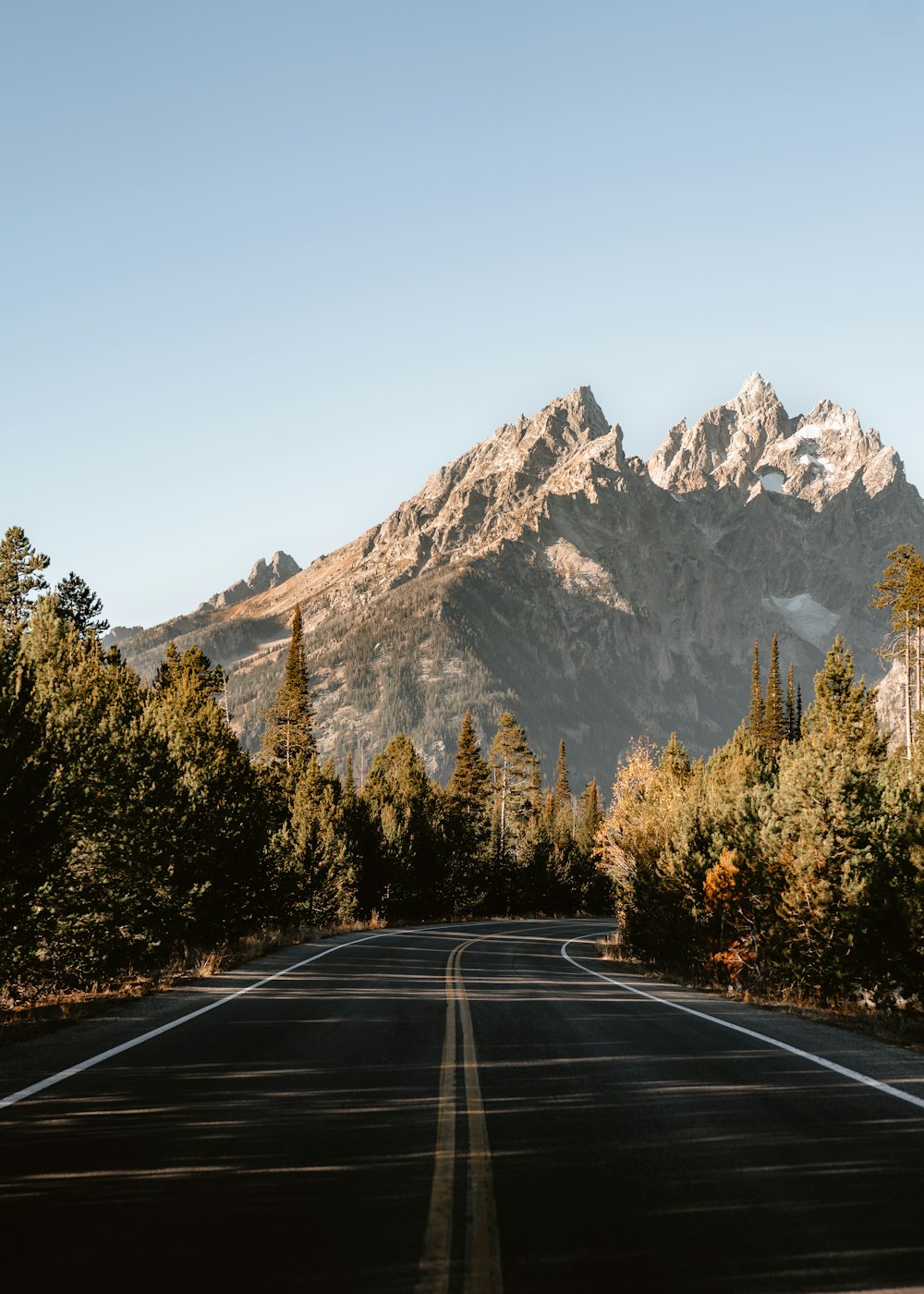 a road with a mountain in the background