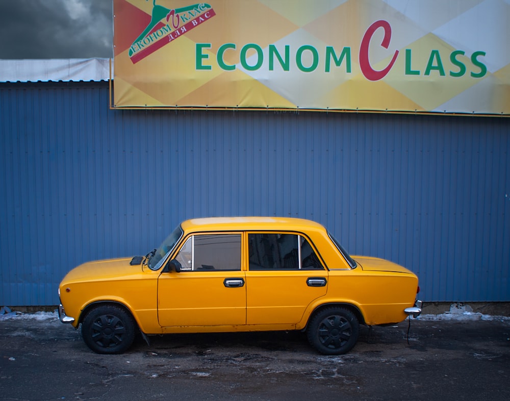 a yellow car parked in front of a building