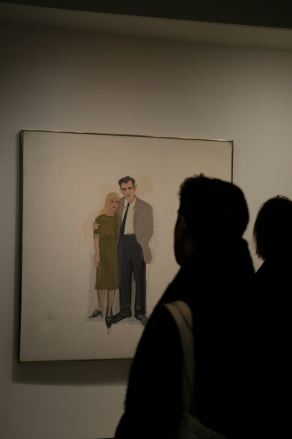 a man looking at a painting of a man in a suit