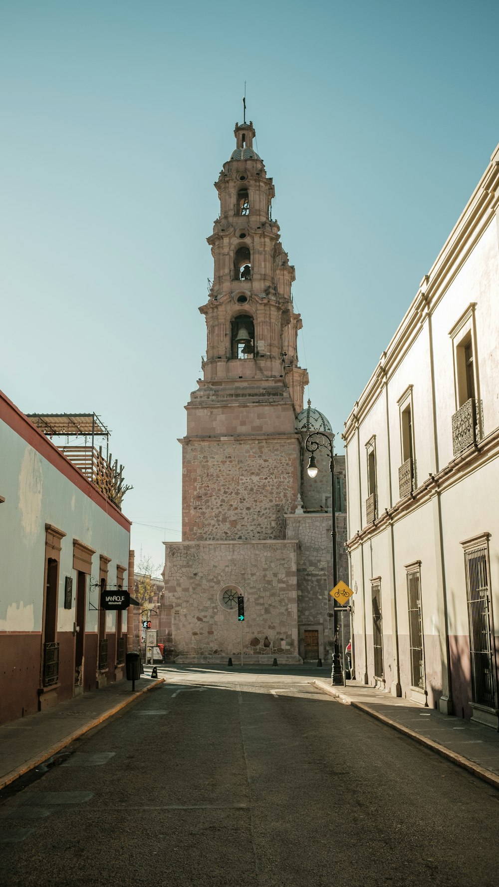 a tall clock tower towering over a city street