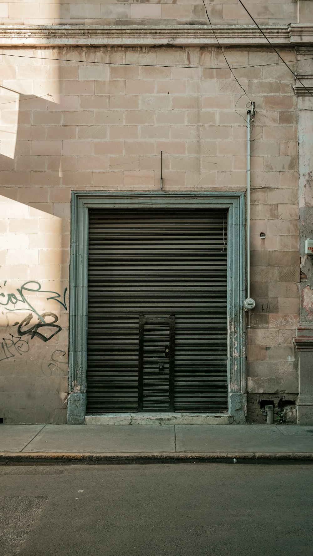 a closed garage door on the side of a building