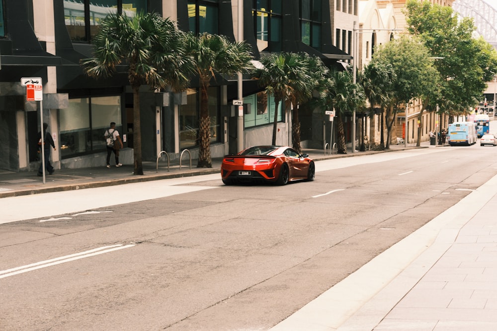 a red sports car parked on the side of a street