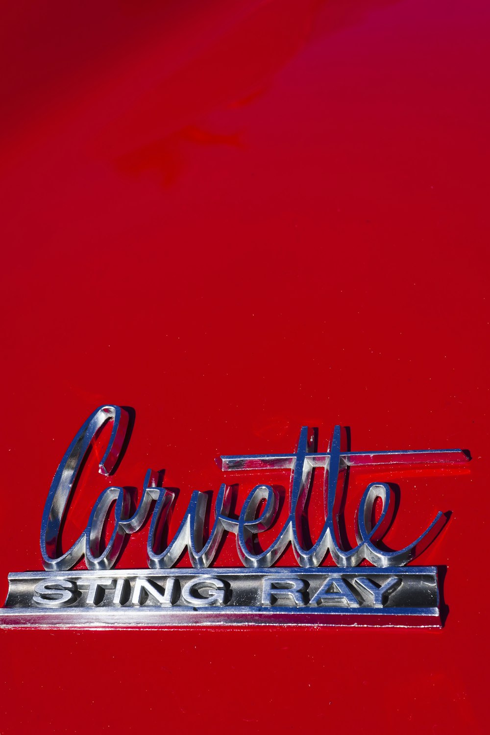 a close up of the emblem on a red car