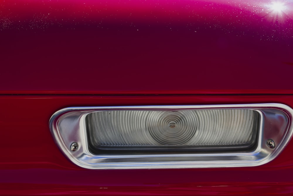 a close up of the front end of a red car