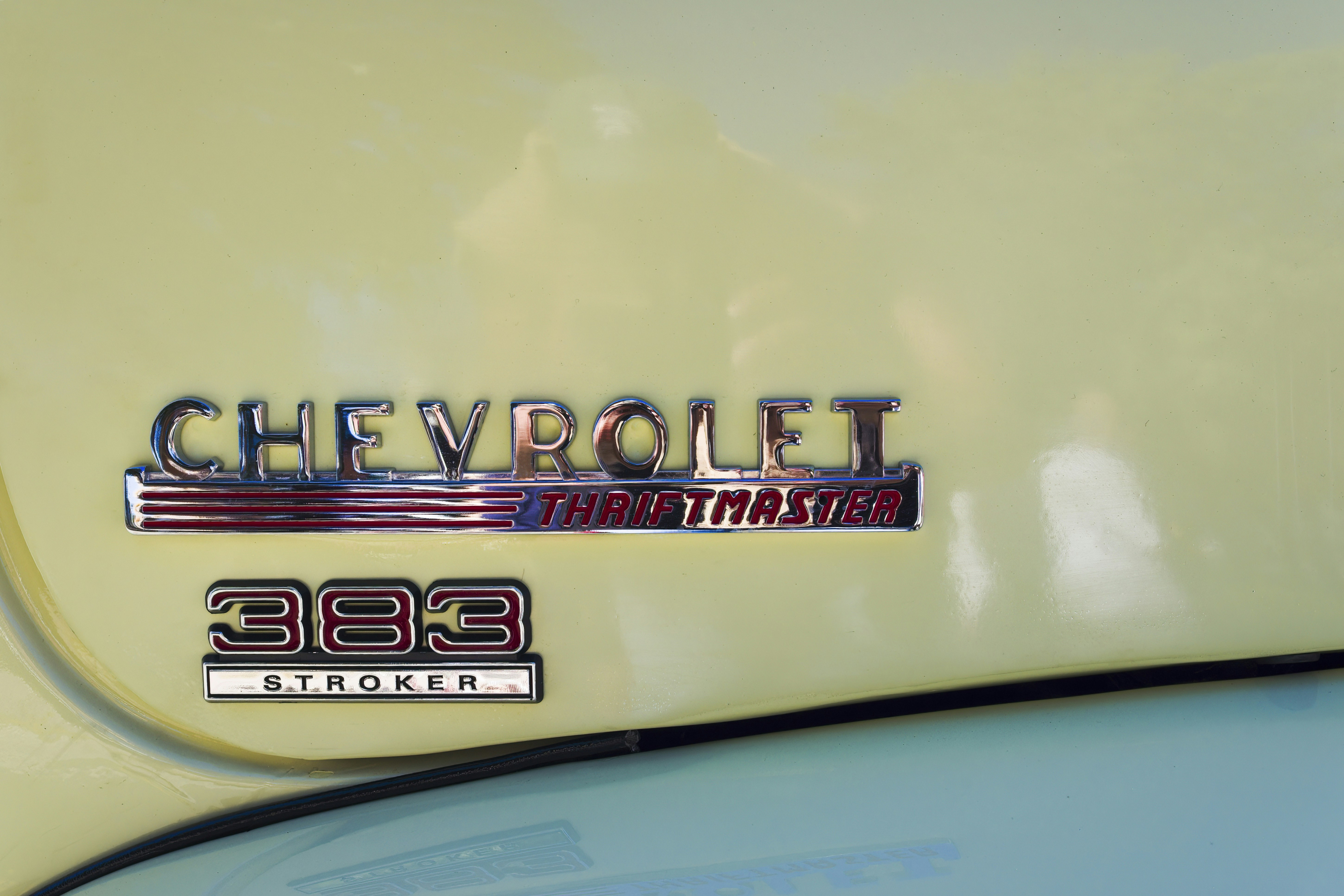 a close up of the emblem on a yellow car, Antic car detail