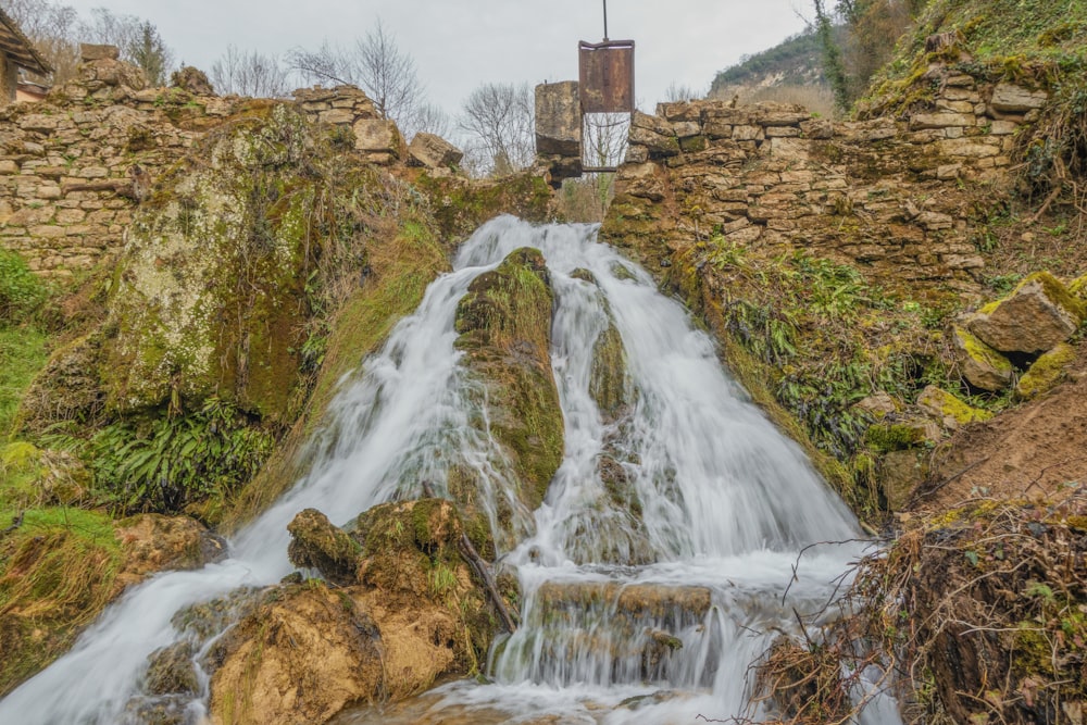 a waterfall with a tower in the background