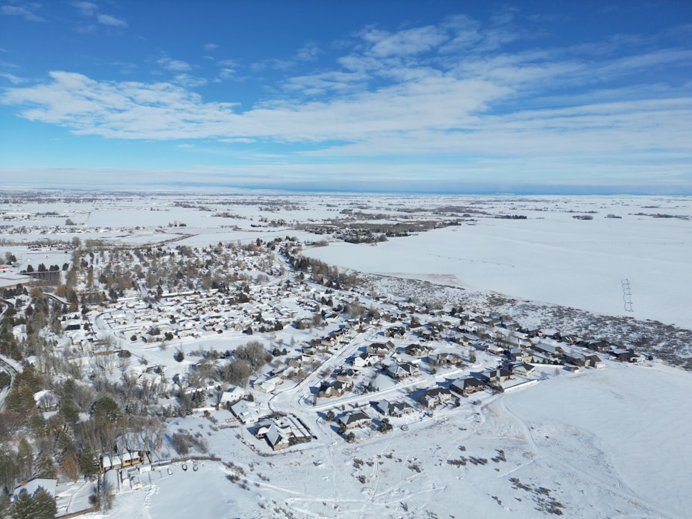 an aerial view of a town in the snow