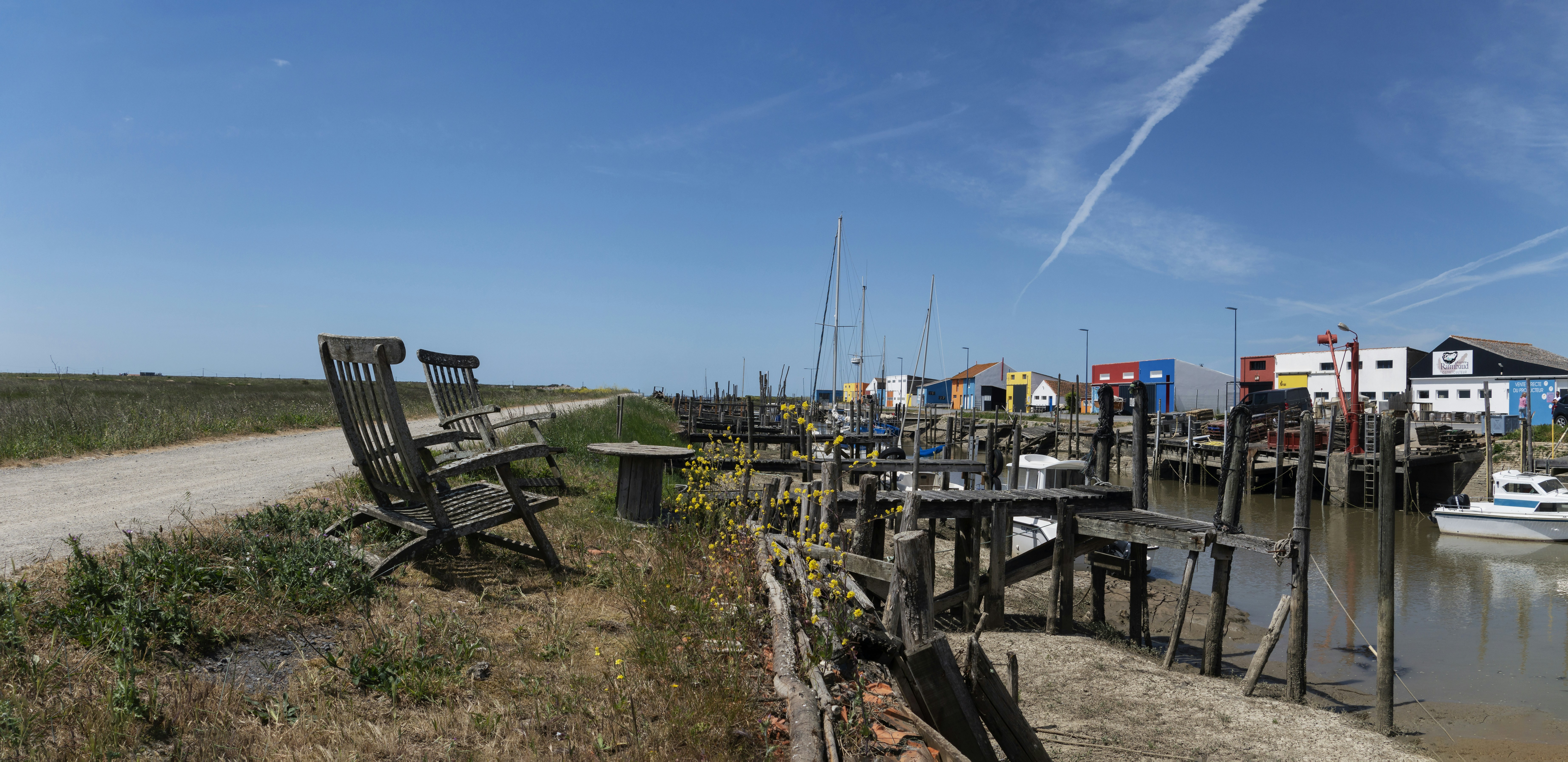 a wooden bench sitting next to a body of water