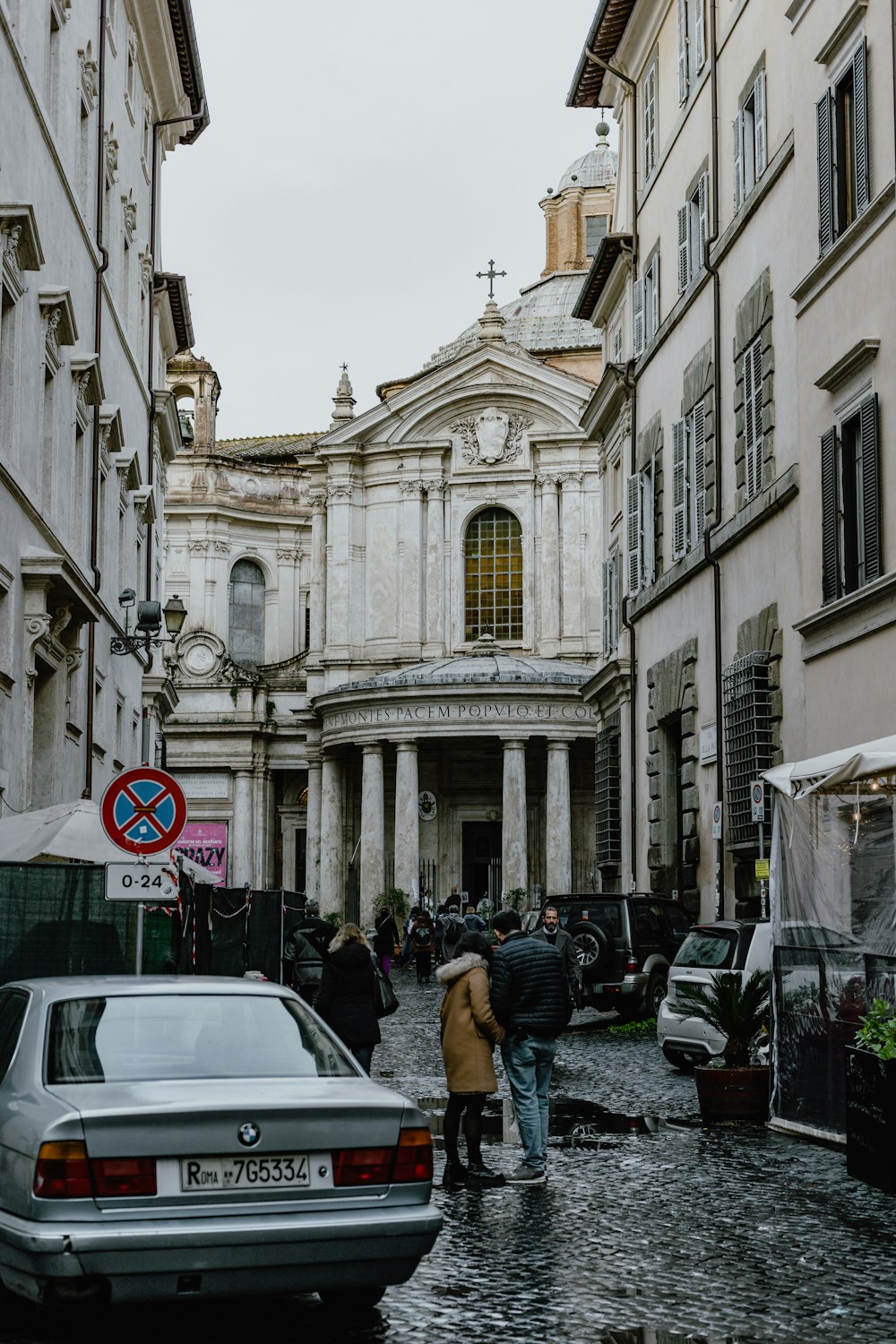 a couple of people that are walking down a street