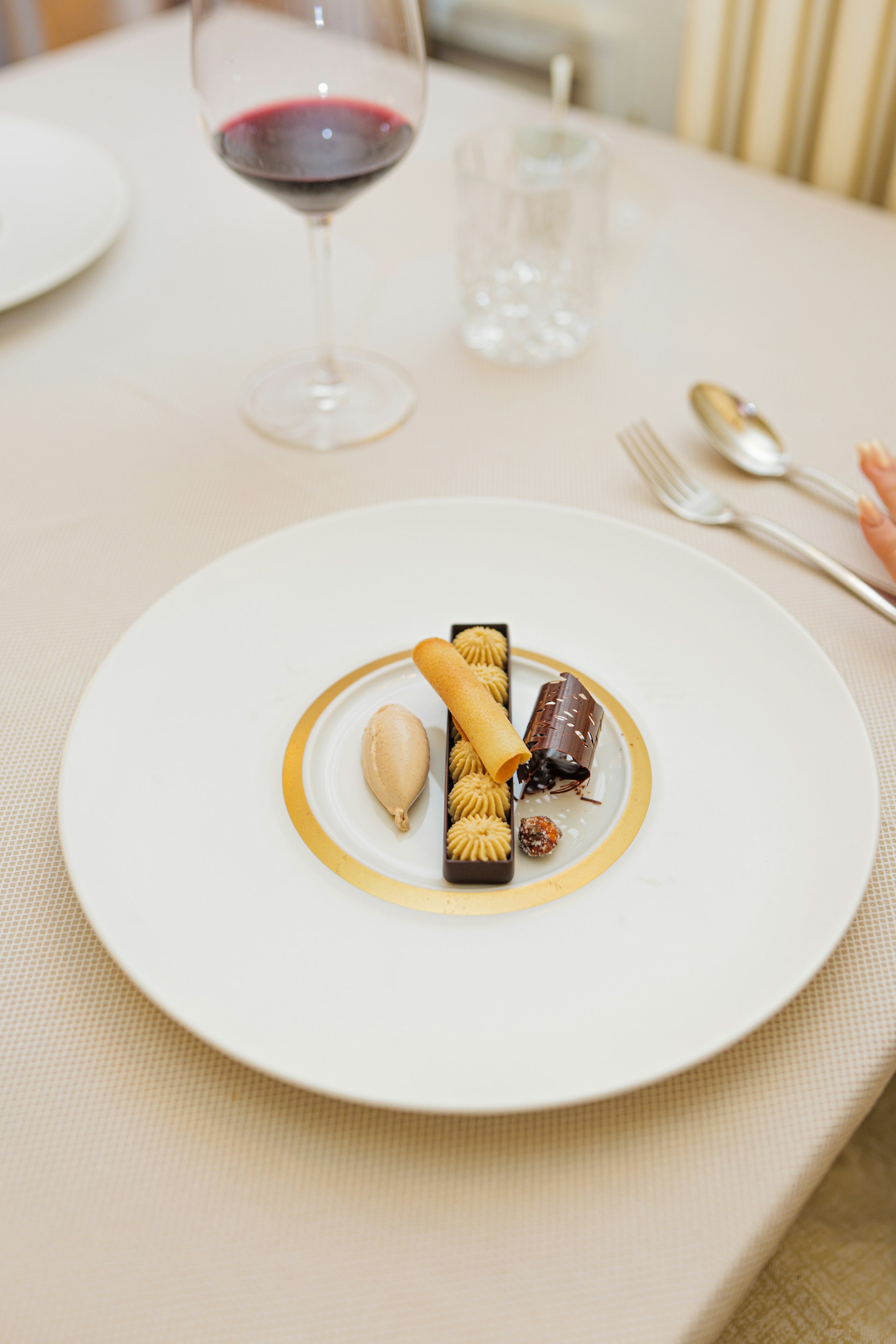 a plate of food on a table with a glass of wine