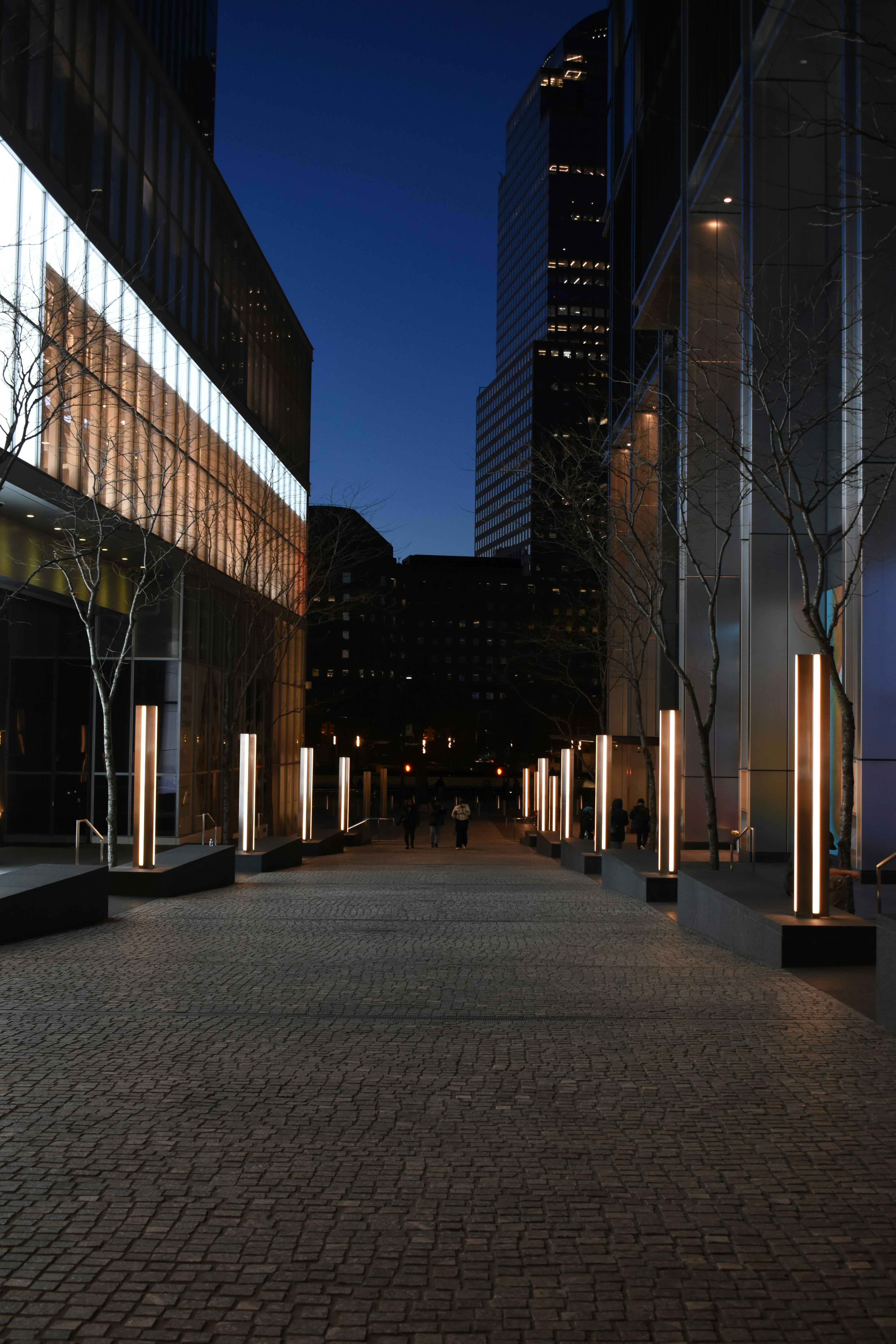 A city street at night with tall buildings photo – Free City Image on ...