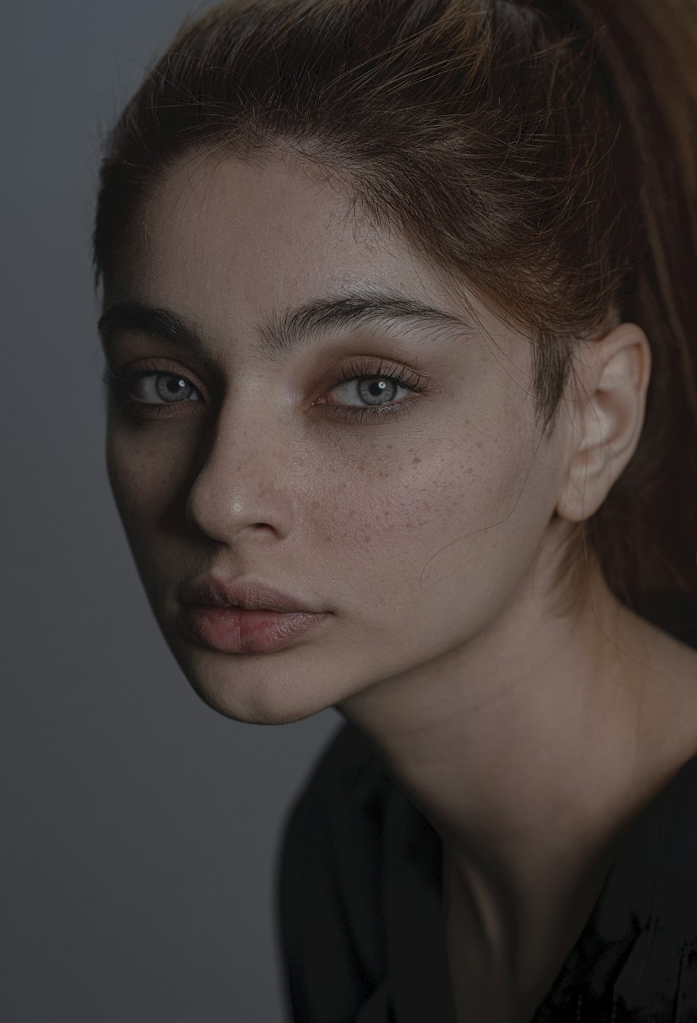 a woman with freckled hair and blue eyes