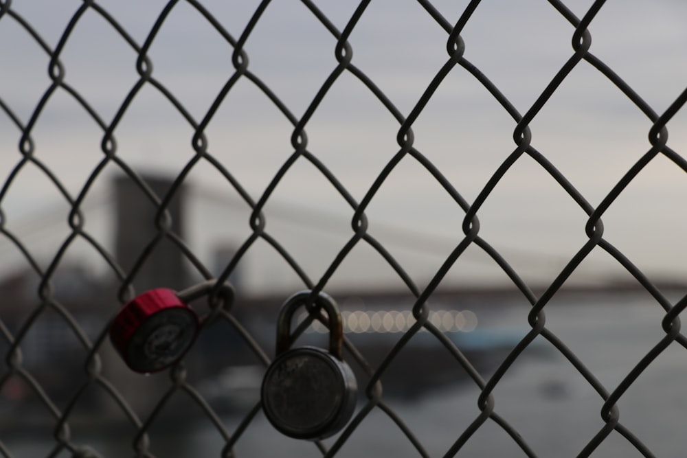 a chain link fence with two padlocks on it