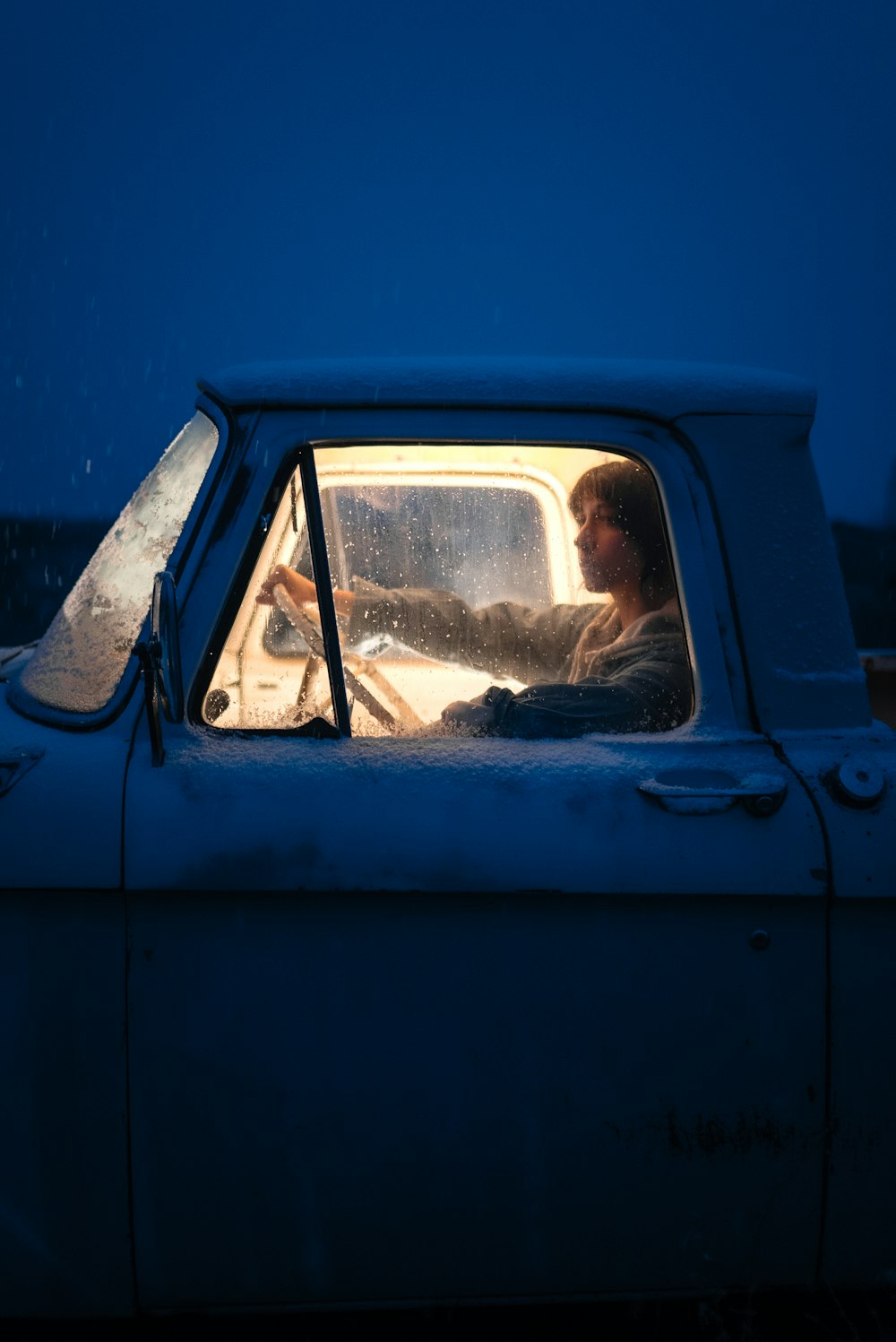a man driving a truck in the dark