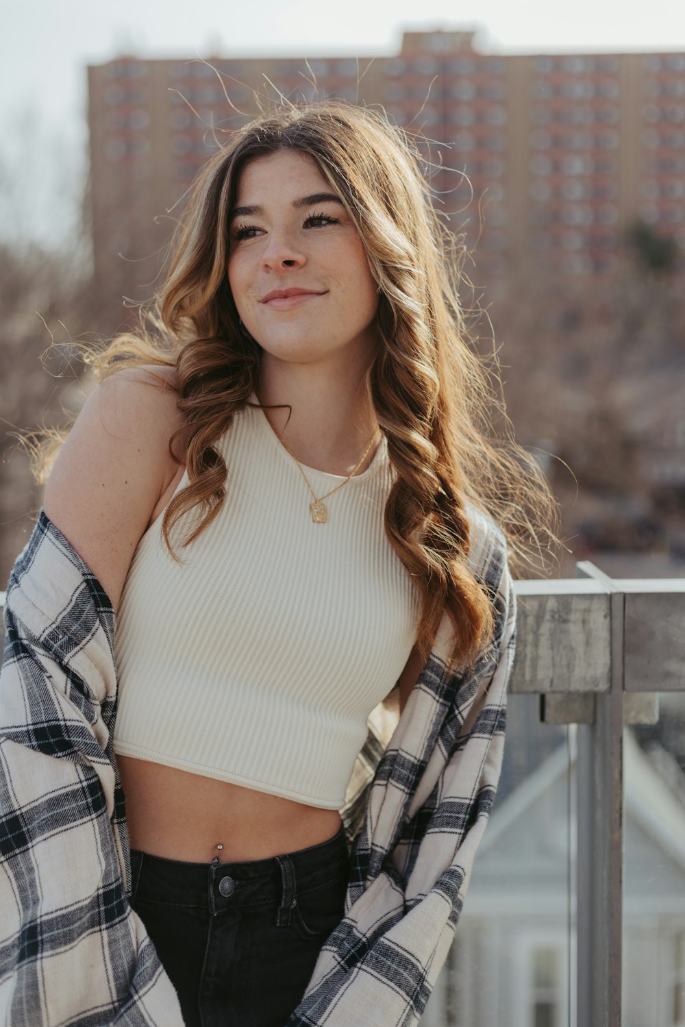 a woman posing for a picture on a balcony