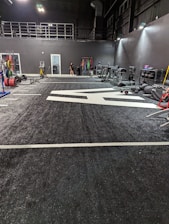 Gym space with training equipment and a rider stretching