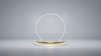 a white and gold object with a circular base