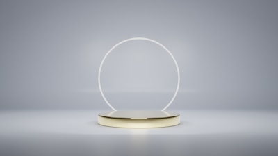 a white and gold object with a circular base