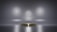 A metallic platform is centered in a minimalistic setting with a reflective surface. Soft, diffused lighting creates circular patterns on the background wall, enhancing the focus on the central stage. The ambiance is sleek and modern, with a hint of elegance.