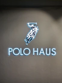 Close-up of the Polo Hub Network signboard with contact details.