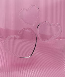 a couple of heart shaped glasses sitting on top of a table