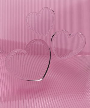 a couple of heart shaped glasses sitting on top of a table