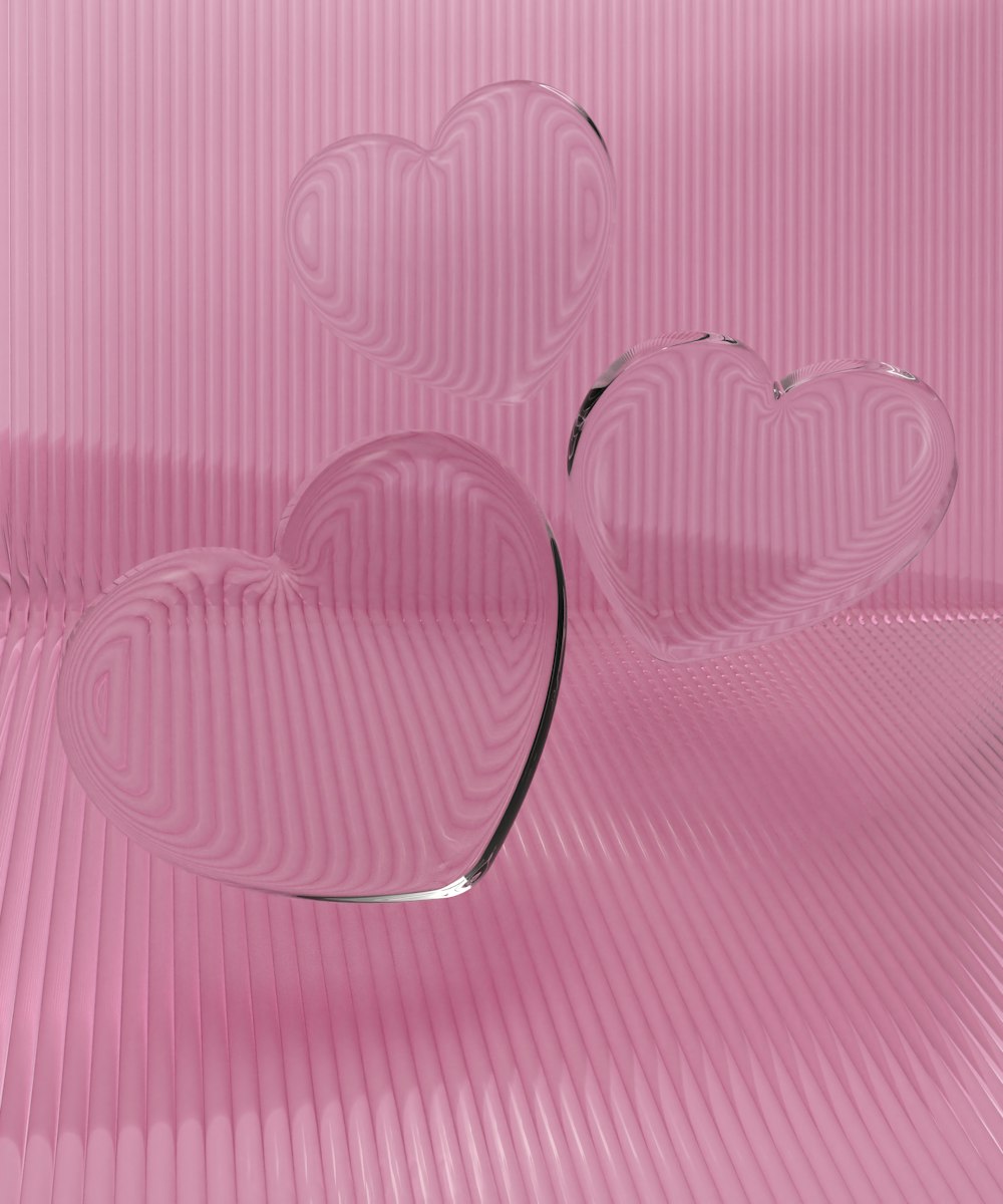 a couple of heart shaped glasses sitting on top of a table