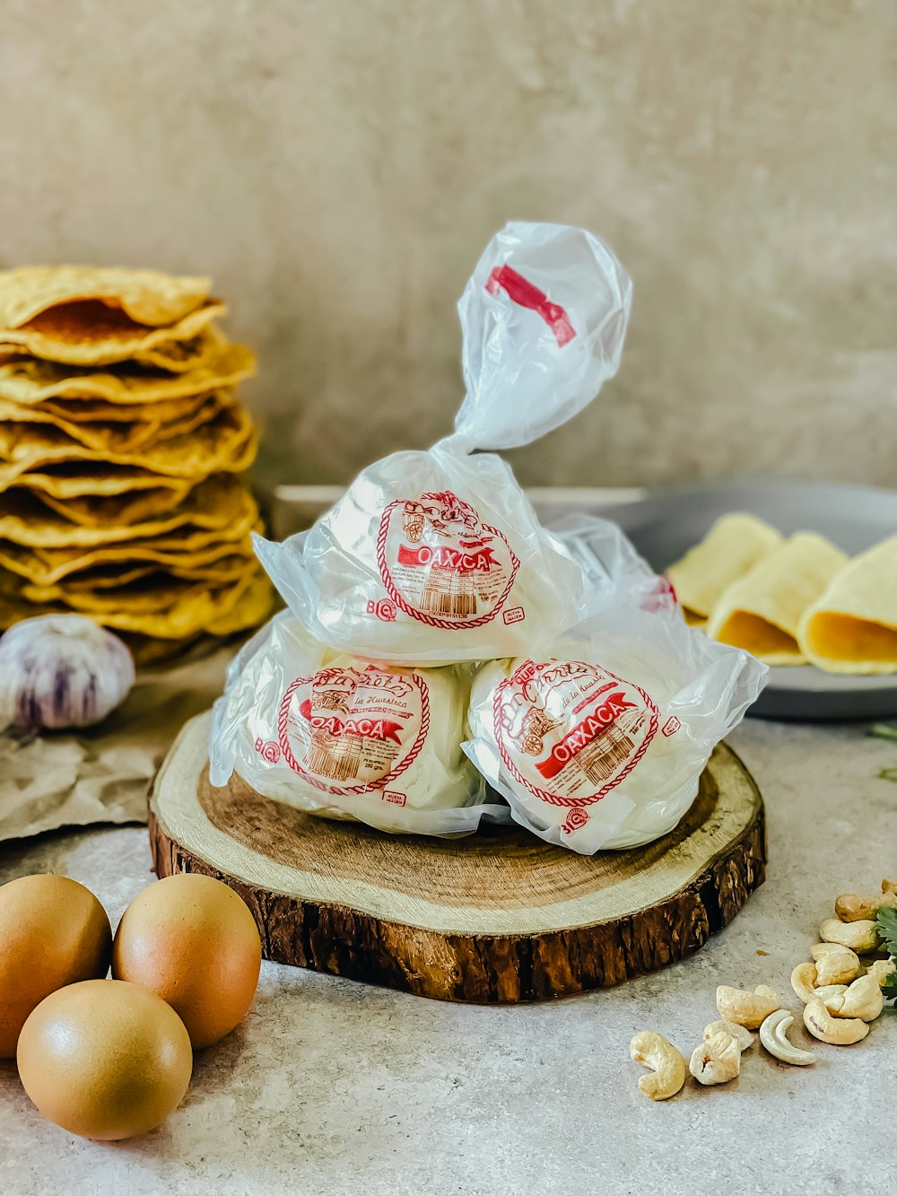 a pile of eggs sitting on top of a wooden slice