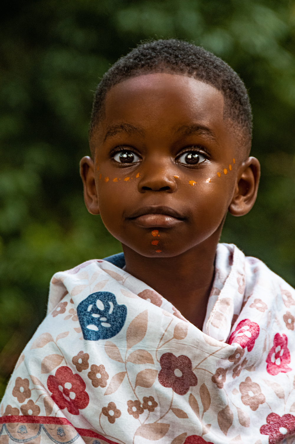 a young boy with a scarf around his neck