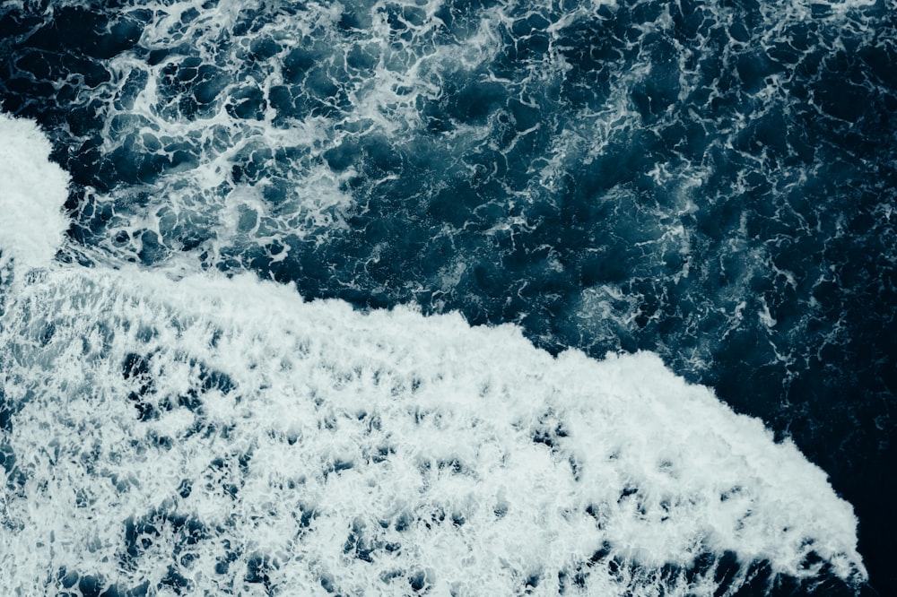 an aerial view of the ocean with waves